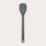 #medium The Zyliss Spoontula is dark gray, with a silicone head, long ergonomic handle, and a gently rounded rectangular bowl, pictured on a plain light background. #Medium