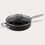 A Zyliss Ultimate Pro Ceramic Saute Pan With Lid, featuring a black nonstick surface, glass lid, long metal handle, and short helper handle, is displayed against a plain light background.