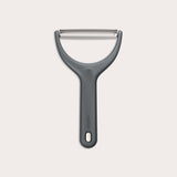 The Zyliss Wide Peeler features a Y-shaped design, ergonomic handle, and horizontal stainless steel blade, shown against a simple light background.