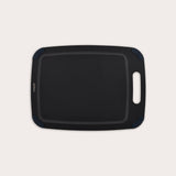 The Zyliss Wood Fibre Cutting Board is a rectangular, black, eco-friendly board with rounded corners, groove edging, right-side handle cutout, and dark blue corner accents. Made from recycled wood fibres. Shown on a plain white background. #Medium