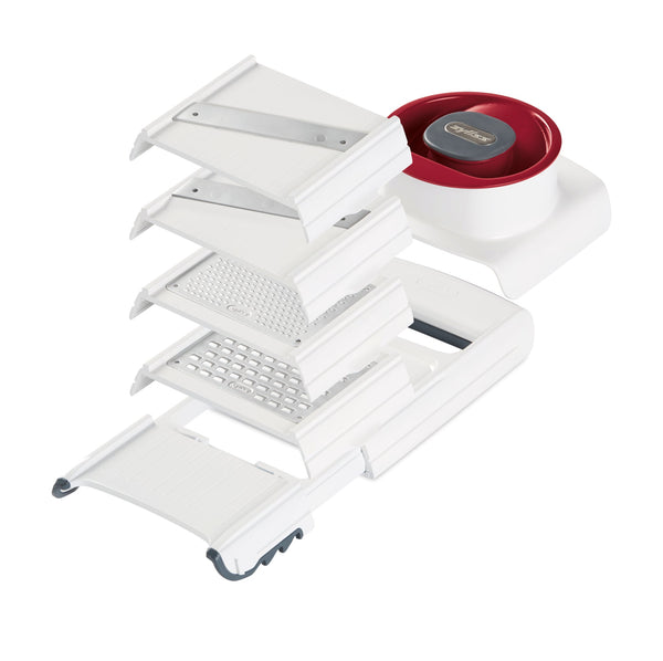 A white and red kitchen mandoline slicer with multiple interchangeable blades and a round food holder, displayed with all components separated and fanned out on a white background.