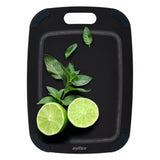 A Zyliss Wood Fibre Cutting Board in black, topped with two lime halves and fresh mint leaves—an eco-friendly board made from recycled wood fibres. #Small