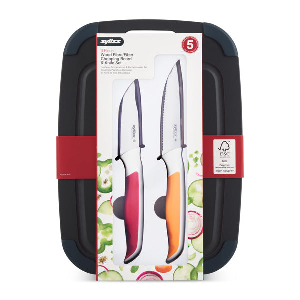 A set of two knives with black, red, and orange handles, packaged on a rectangular dark cutting board with a background of sliced vegetables and product information listed on the front.