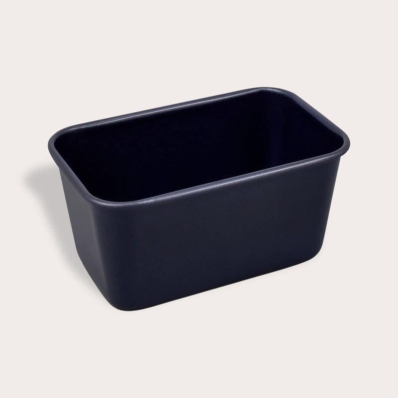 A rectangular, deep, dark-colored Zyliss Durable Non-Stick Loaf Pan sits on a light background. A circular label in the top left corner reads 3 for 2 mix & match. #1L/1lb