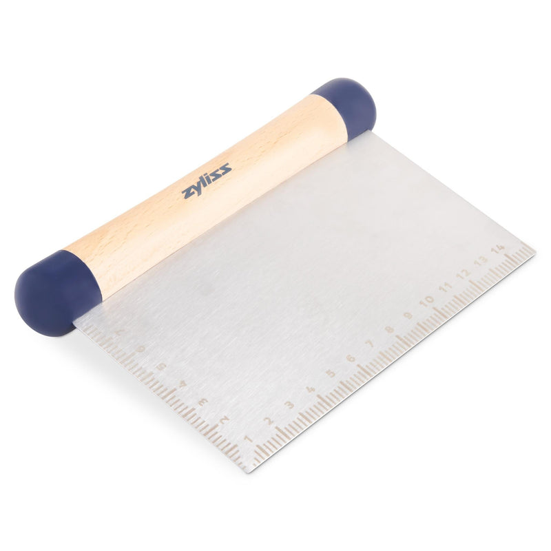 A metal bench scraper with a wooden handle, blue end caps, and a ruler engraved along one edge, designed for baking and kitchen use.