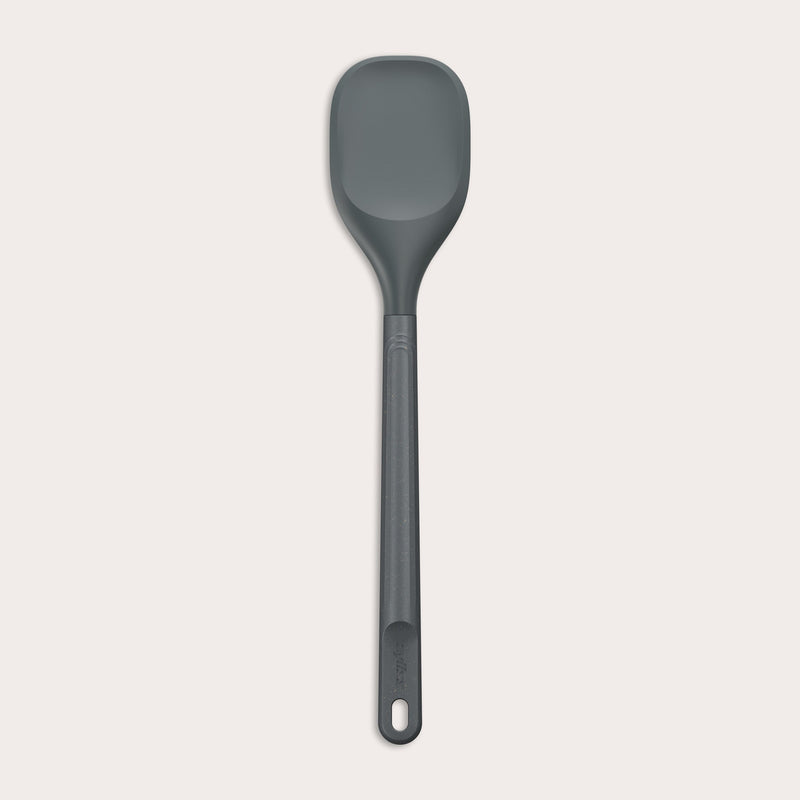 #large A Zyliss Spoontula with a dark gray, rounded silicone head and a long ergonomic handle, featuring a small hanging hole near the end, is displayed against a light background. #Large