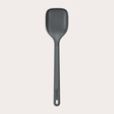 #large A durable Zyliss Spoon in dark gray silicone, featuring a long handle with a hole at the end, displayed on a plain light background. #Large