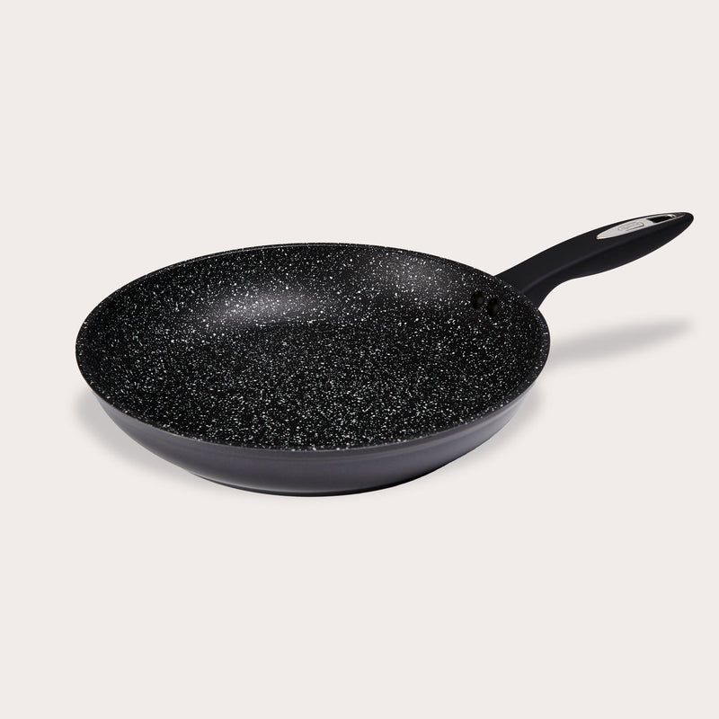 The Zyliss Ultimate Non-Stick Frying Pan features a black, scratch-resistant surface with a speckled white pattern and a black handle, shown on a plain light background. #28cm/11"