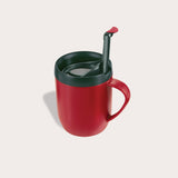 The Zyliss Hot Mug Cafetière Mug in red features a handle, double-wall insulation, dark green lid, and matching green spoon on a light background—ideal for coffee lovers on the move. #red