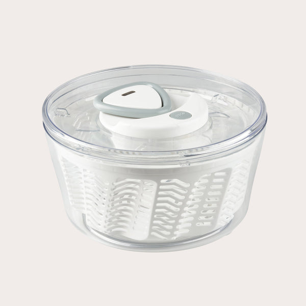 The Zyliss Easy Spin 2 Salad Spinner Large features a clear plastic bowl, white interior basket, gray and white lid, and non-slip base—ideal for washing and drying salad greens with ease. #White