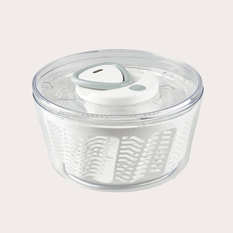 The Zyliss Easy Spin 2 Salad Spinner Large features a clear plastic bowl, white interior basket, gray and white lid, and non-slip base—ideal for washing and drying salad greens with ease. #White