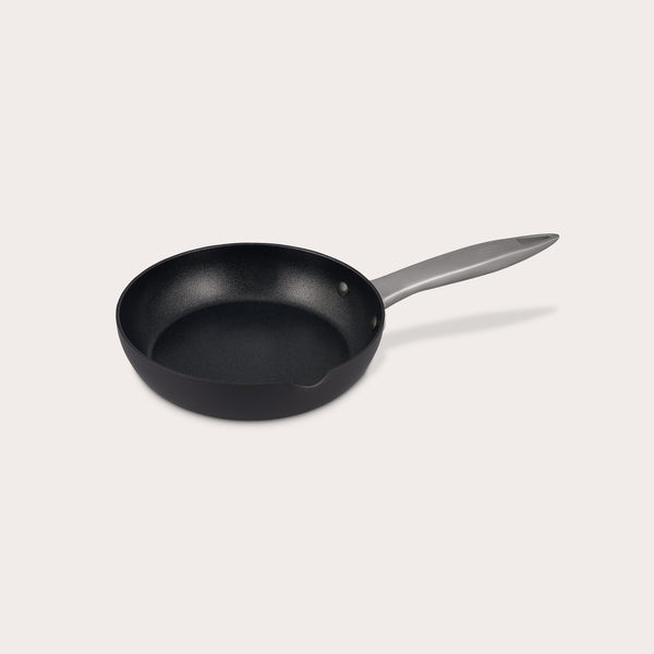 The Zyliss Ultimate Pro Non-Stick Frying Pan With Pouring Lip features a black, Swiss-coated hard-anodized aluminum body and a long gray handle, shown on a plain white background. #20cm/8"