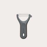 A Zyliss Y Peeler with a stainless steel swivel blade, ergonomic handle, and end hole is shown in black on a plain white background.
