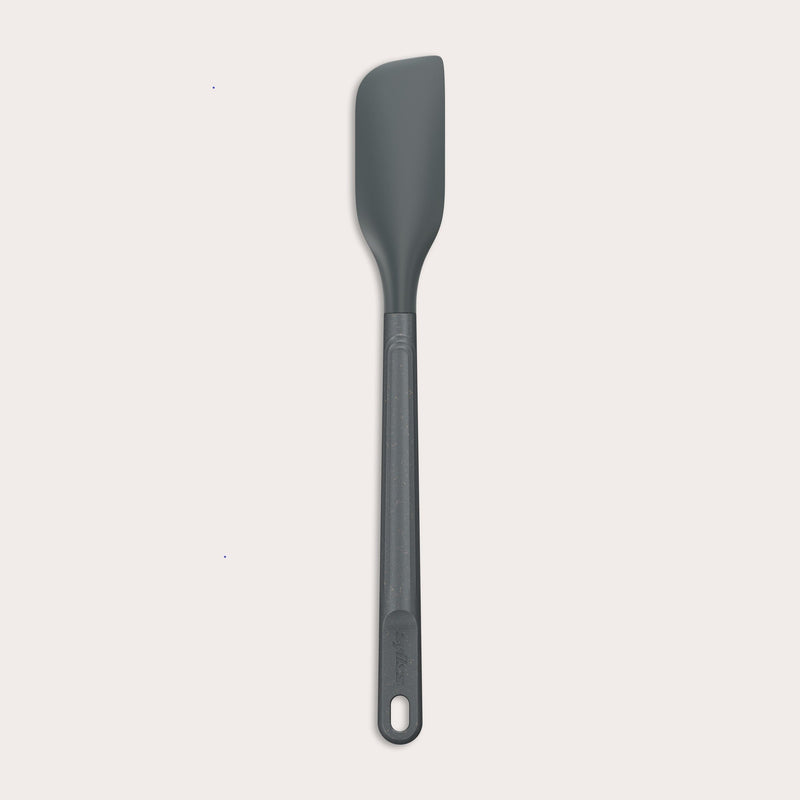 The Zyliss Spatula, featuring a long handle and flat, angled grey silicone head, is displayed against a plain white background.